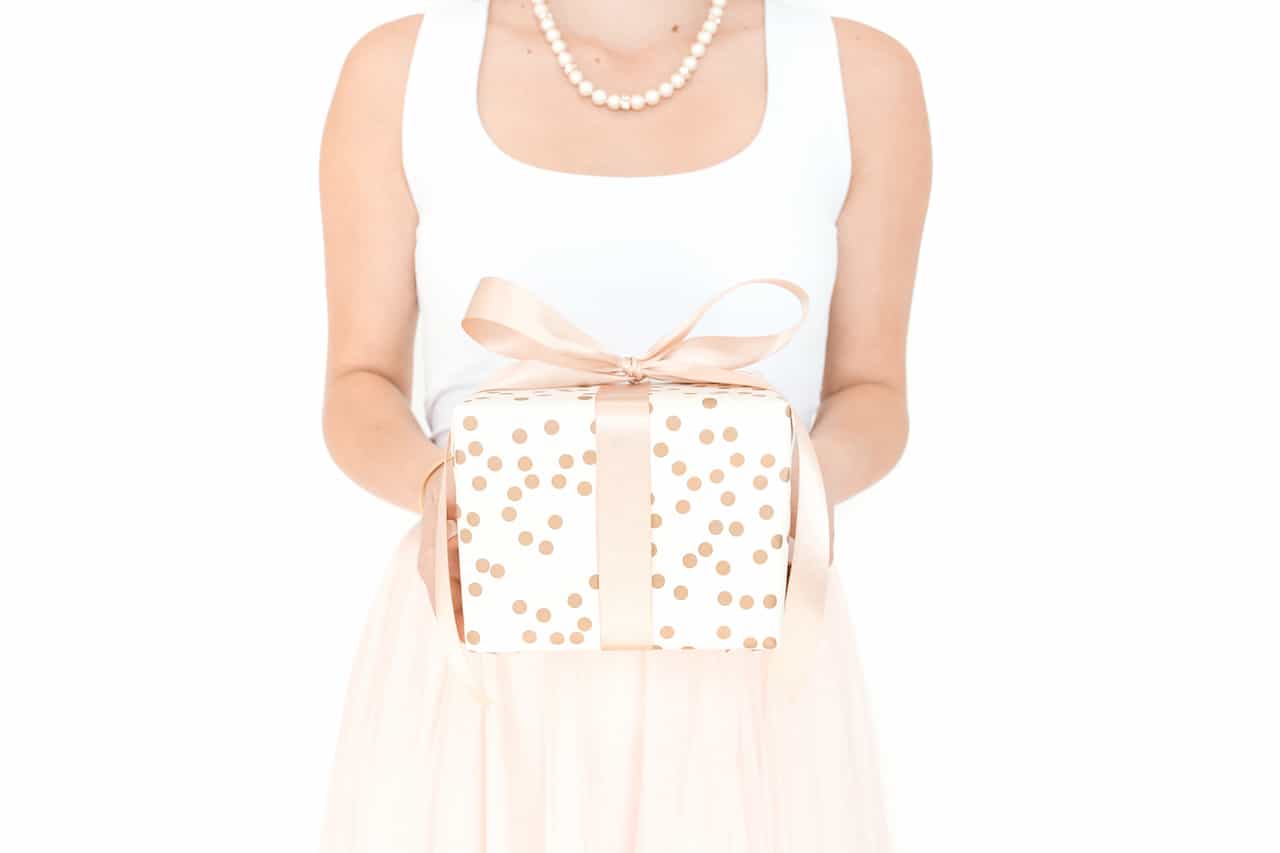 hostess gift ideas woman holding beautiful wrapped gift