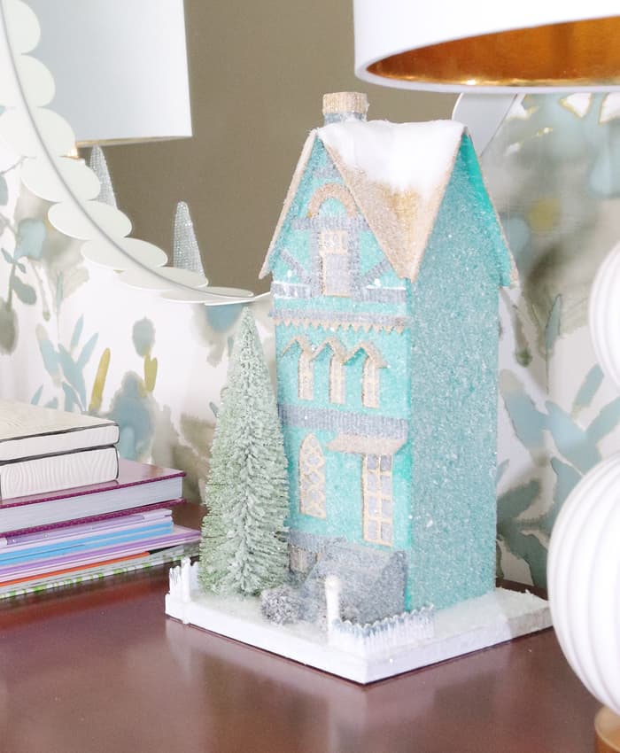 Cody Foster blue glitter house with white mirror and Thibaut wallpaper in the background.