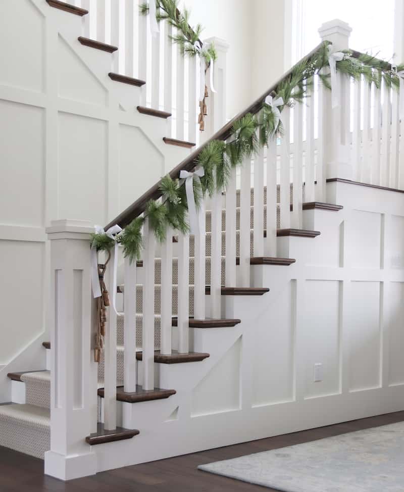 neutral textured home tour full stairs with faux garland
