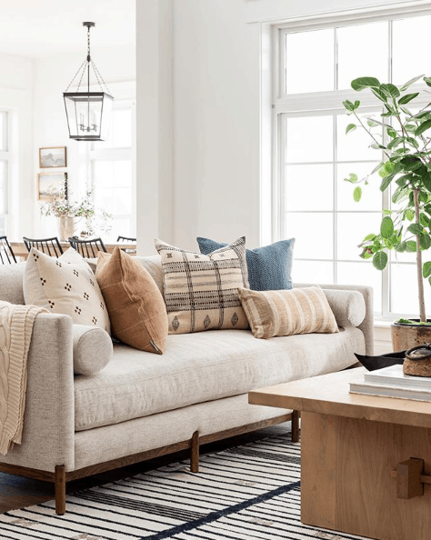 Neutral transitional sofa with warm neutral colored pillow arrangement