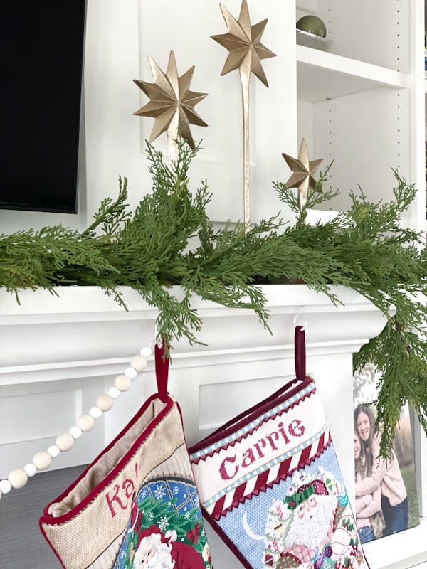Christmas mantel with garland and colorful stockings