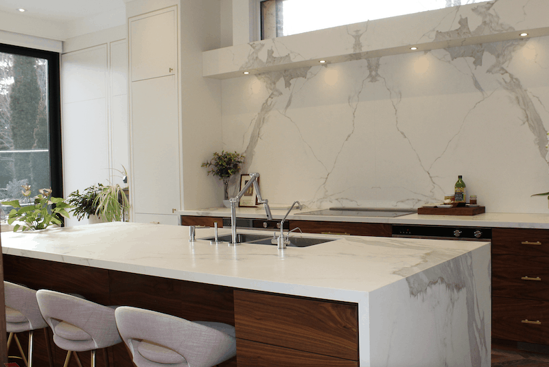 kitchen with porcelain countertops that have grey veining and resemble marble