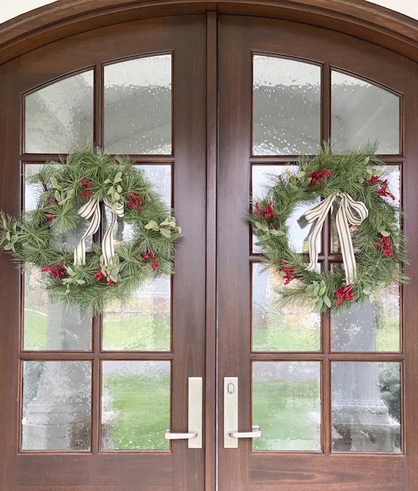 faux wreath hearth and hand target with red berries and striped grograin ribbon on front door windows